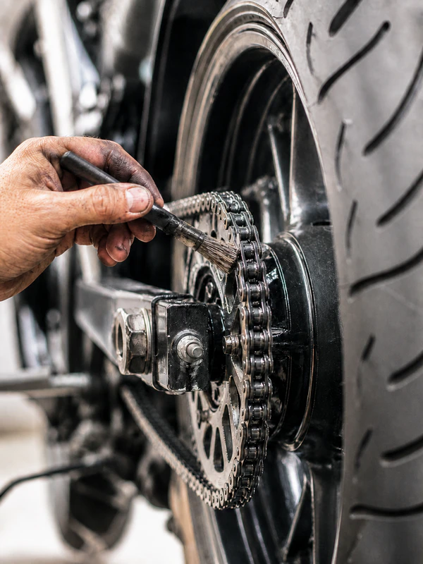 Motorcycle maintenance picture of chain lubing